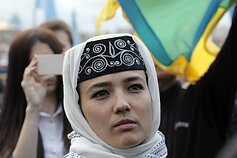 A Crimean Tatar woman in a national costume attends a rally to mark the 72nd anniversary of the deportation of Crimean Tatars in Kiev, Wednesday, May 18, 2016