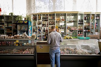 Tourists and local service workers use the only shop available in the area