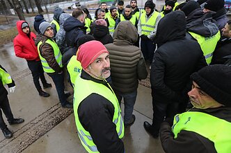 Turkish construction workers protest unpaid wages near a stadium construction site in Kaunas