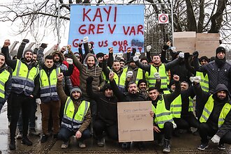 Turkish construction workers protest unpaid wages near a stadium construction site in Kaunas