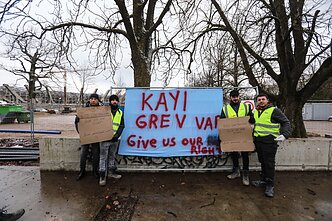 Turkish construction workers protest unpaid wages near a stadium construction site in Kaunas