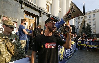 Activist protest outside the president's office in Kyiv prior to the ceasefire