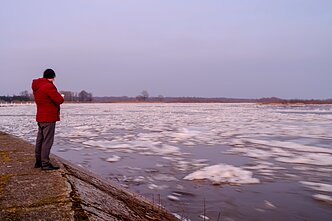 A man watches the floating ice. A man watches the floating ice.