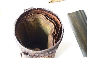 Researchers discover gas mask bag in Lithuania containing partisan documents.