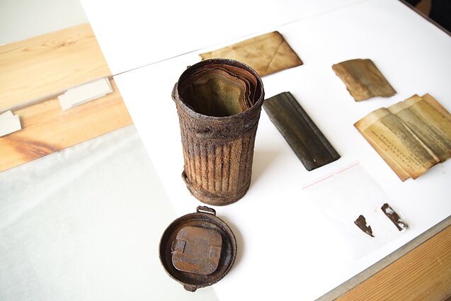 Researchers discover gas mask bag in Lithuania containing partisan documents.