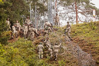 Lithuanian troops build a border fence with Belarus.