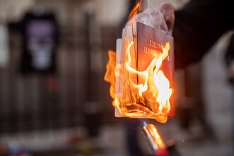 Belarusians burn their passports outside the Ukrainian Embassy in Vilnius