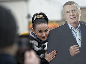 A woman poses with a cardboard cutout of Vladimir Zhirinovsky A woman poses with a cardboard cutout of Vladimir Zhirinovsky