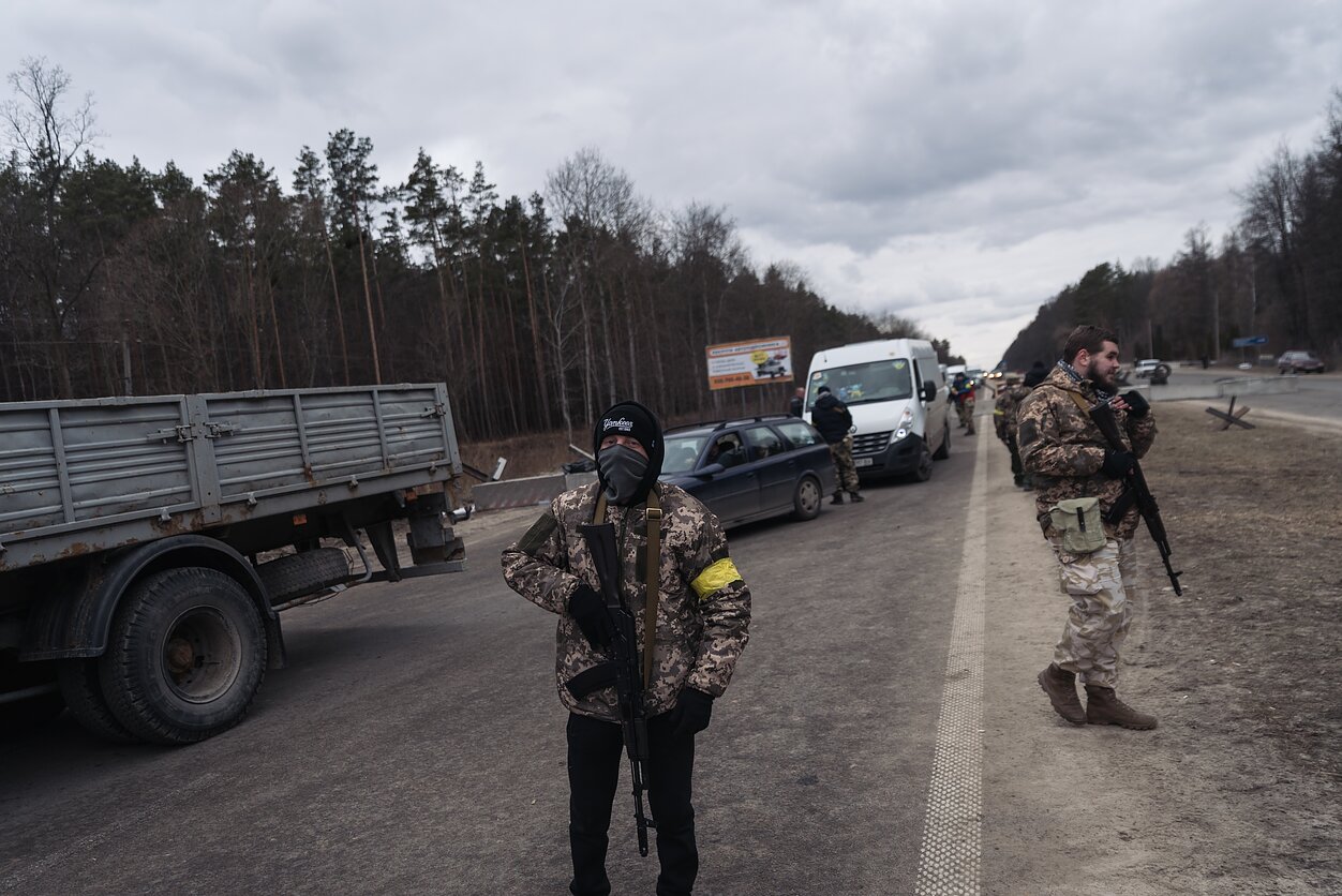 As the invasion began, volunteers set up checkpoints around cities, towns and villages, fortifying the approaches as the armed civilians and the military prepared for the Russian advance.