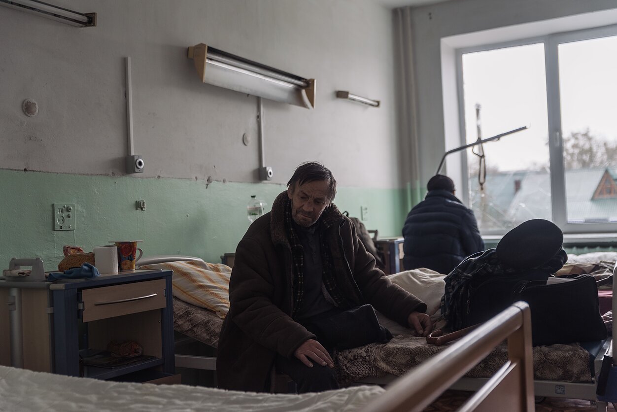 A man sits inside a hospital damaged by an aistrike in Zhytomyr.
