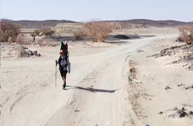 Į futbolo čempionatą pėsčiomis per dykumą: kad kuprinė neapsunktų, keliautojas maitinasi maistu iš degalinių