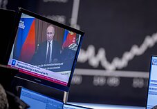 Russian President Vladimir Putin on a screen
