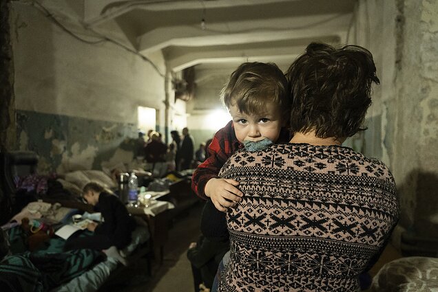 Woman holds a child, Mariupol, March 2022