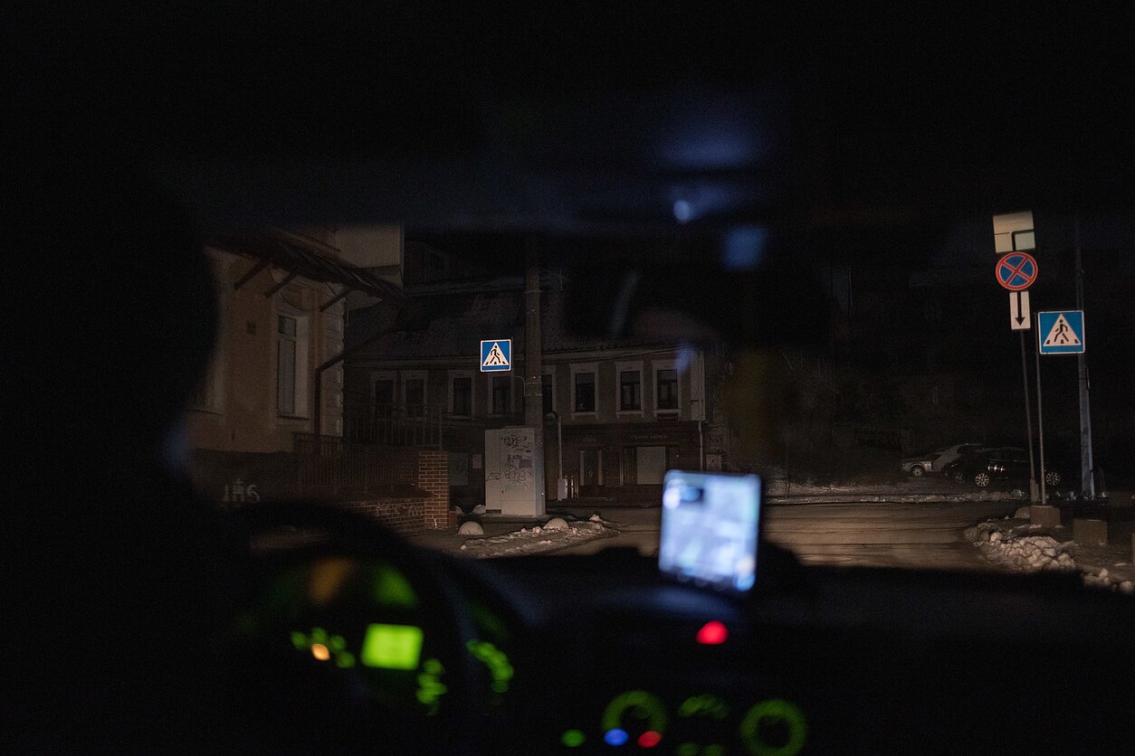 From inside a car driving through the dark streets of Kyiv. From inside a car driving through the dark streets of Kyiv.