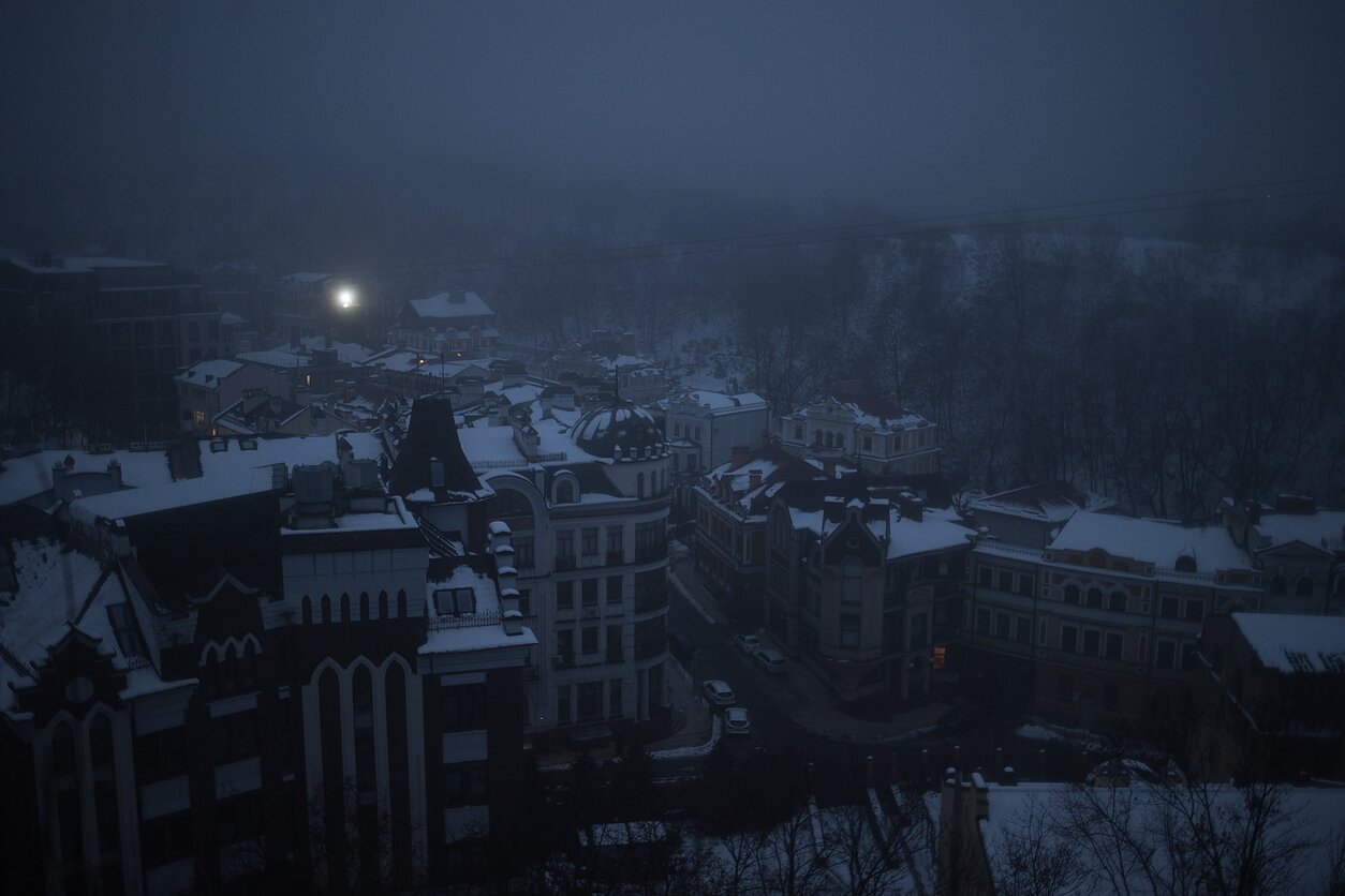 Podil area of Kyiv. Through the windows of darkened apartment blocks, candles flicker in the darkness. Podil area of Kyiv. Through the windows of darkened apartment blocks, candles flicker in the darkness.