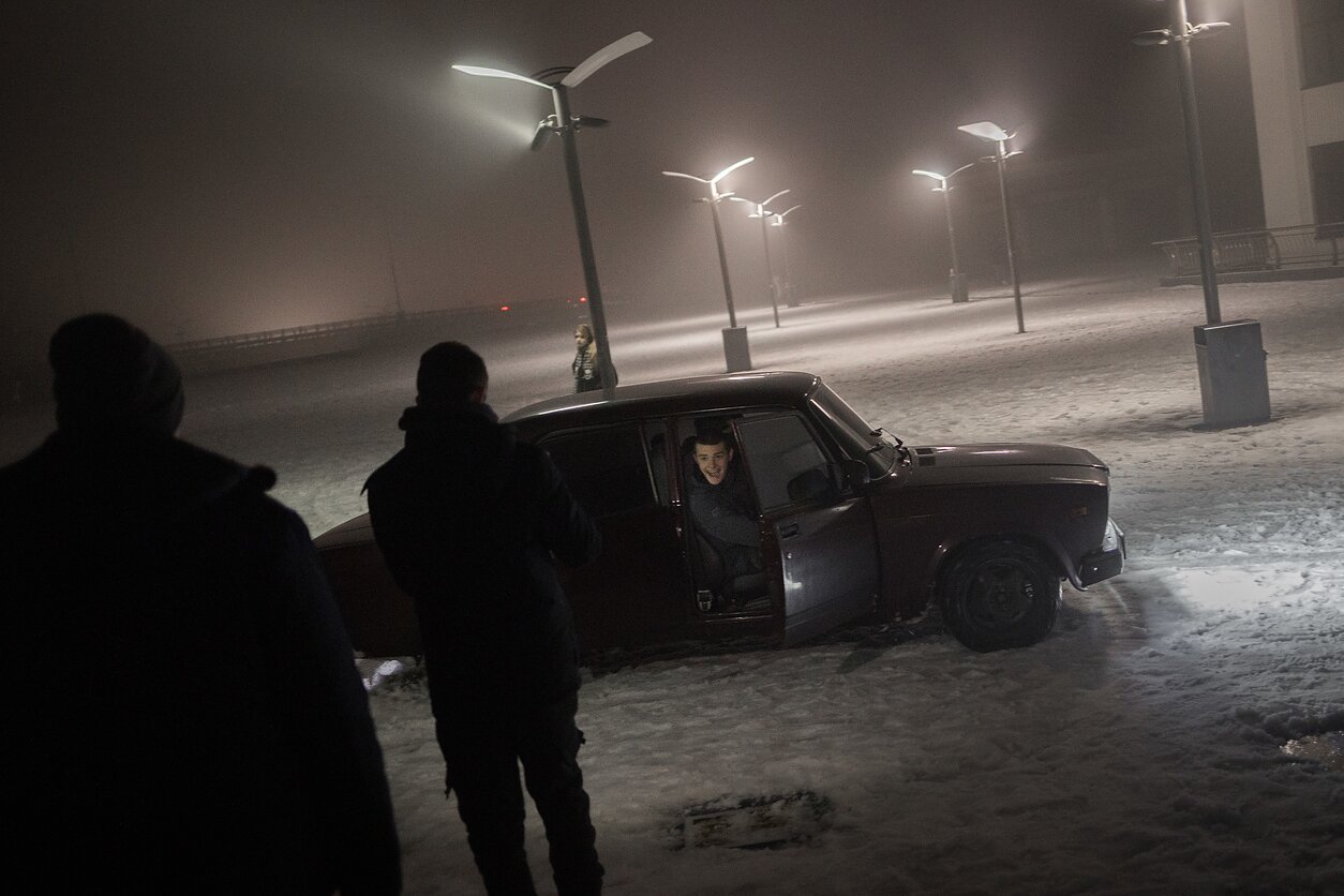 Youths drive around in a Lada through the snow in central Kyiv. The area is a popular hangout spot for young people looking for fun in a quiet city. Youths drive around in a Lada through the snow in central Kyiv. The area is a popular hangout spot for young people looking for fun in a quiet city.