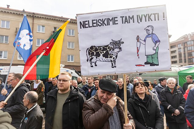 Lithuanian dairy farmers stage a protest outside the parliament in Vilnius. The poster reads "Let's not allow this to happen"