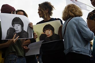 Protesters carry images of Marie Trintignant in a rally against Bertrando Cantat concerts