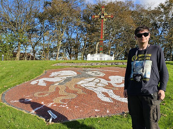Augustinas Žemaitis near a monument at a DP camp in Denmark