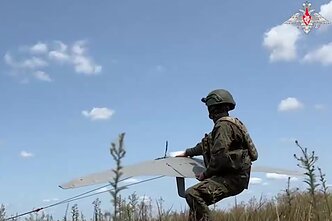 A Russian soldier with a drone in Ukraine