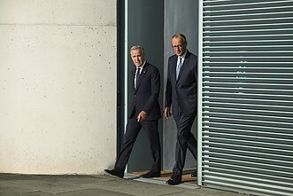 Markas Carney ir Friedrichas Merzas