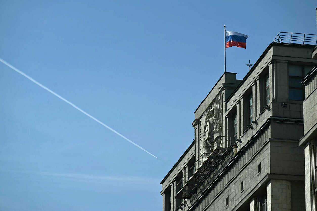 An airplane flies over the State Duma building (lower house of parliament) in central Moscow.