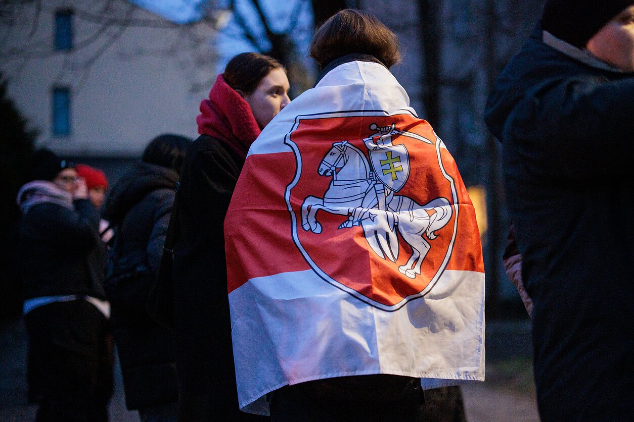 People greet released political prisoners in front of the US embassy in Vilnius.