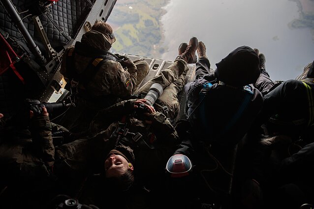 As Russia continues its aggressive policies, the Lithuanian Armed Forces carry out a range of military exercises. Soldiers train both independently and alongside allies, taking part in joint drills. In the photo, the day-to-day life of a Lithuanian soldier is on display. The military photographer is seen resting while waiting for a plane to arrive so it can be captured.