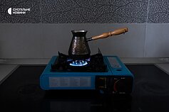 The portable gas burner allows the family to heat food and water for drinks during a power outage.