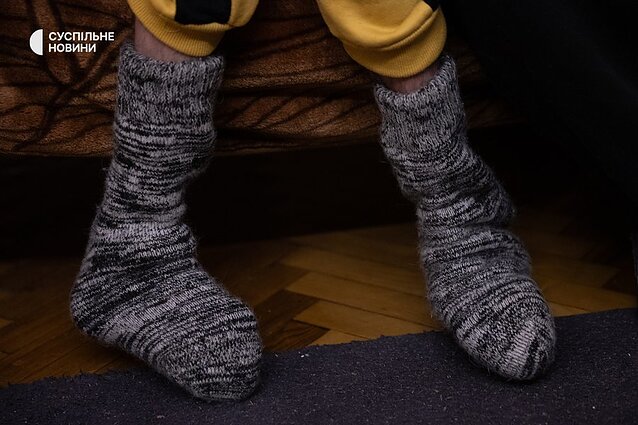 Bohdan is sensitive to the cold and freezes very quickly due to poor circulation. Grandma Nina puts woollen socks and a warm vest on him.