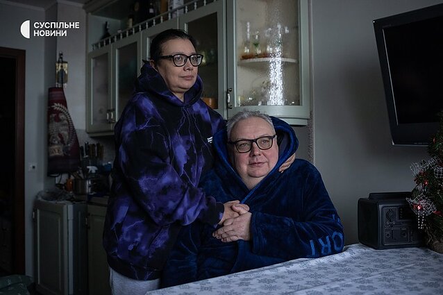 Serhii and Natalia in their apartment in the Solomyanskyi district, where emergency power cuts are in effect.