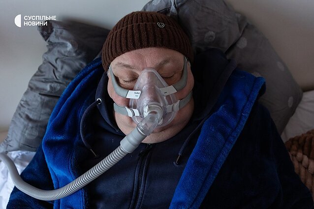 Serhii sleeps with a CPAP machine. He has severe sleep apnoea. The mask allows him to breathe, because without respiratory support, Serhii would be at increased risk of stroke or heart attack.