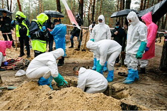 Exhumation of bodies at a mass grave site in Izyum