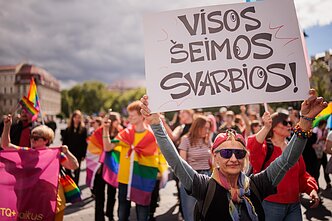 Marcher holding a sign "All families matter" at Lithuanian Pride march, 2026 Marcher holding a sign "All families matter" at Lithuanian Pride march, 2026